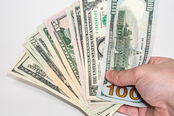 U.S. dollars in hand on a white background, american dollars