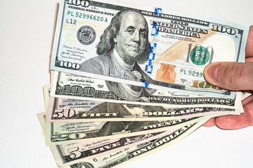 U.S. dollars in hand on a white background, american dollars
