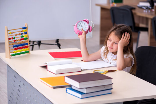 Small girl preparing for exams at home