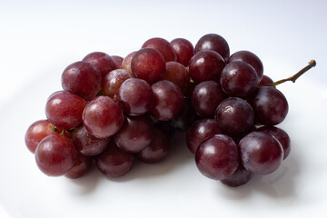 Bunch of red globe grapes isolated on white background