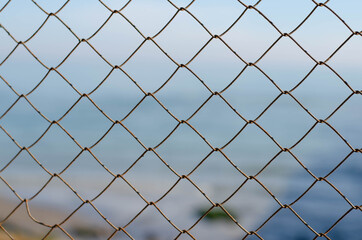 Rusty, metal mesh. Steel wire. Mesh fence.