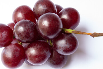 Small bunch of red globe grapes isolated on white background