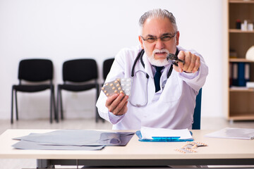 Old male doctor committing suicide at workplace