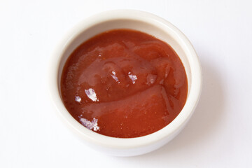 Small jar with guava jam isolated on white background
