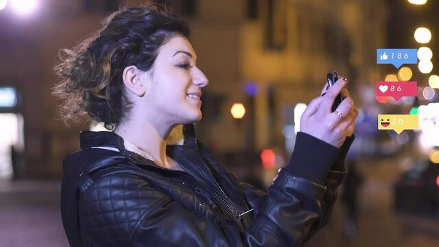 social, globalization - beautiful girl takes a selfie on the street at night