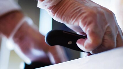 Taking kitchen knife from desk. Close up.