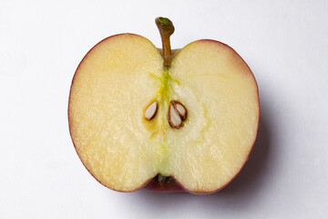 Top view of red apple cut in half on white background