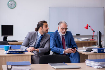 Two male employees working in the office