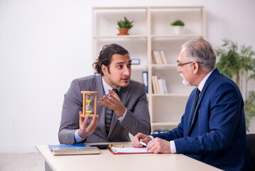 Two businessmen in time management concept
