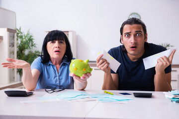 Female pensioner and her young son in budget planning concept