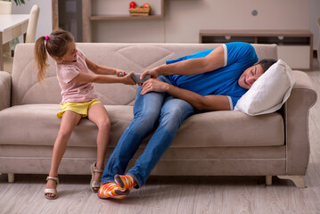 Young man with his daughter at home