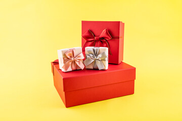 A pile of gift boxes on yellow background
