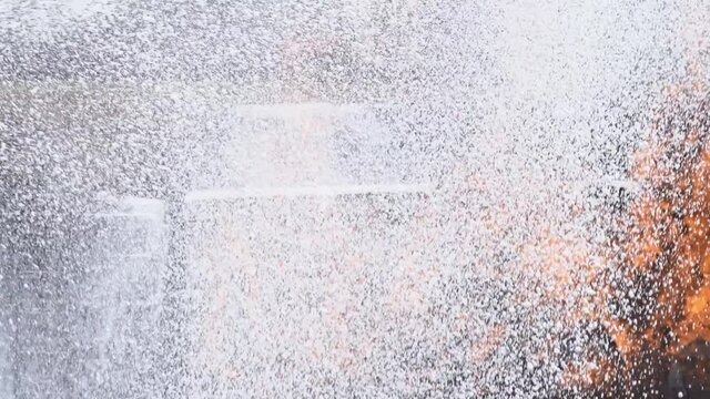 Firefighter teamwork fighting a fire on danger rescue duty. Three fireman in fire protection suit spray firefighting foam from fire hose extinguishing fire flames on burning leaked gas pipeline.