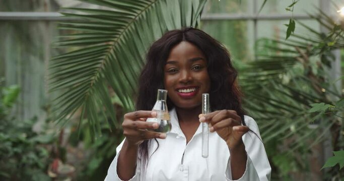 Female woman ecologist scientist biologist researcher with test tube liquid, samples ground plant in Petri dish in lab, Biological research genetic engineering laboratory, food farming 4 K slowmo