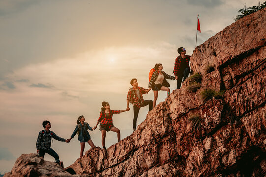 Group Of People On Peak Mountain Climbing Helping Teamwork , Travel Trekking Success Business Concept.