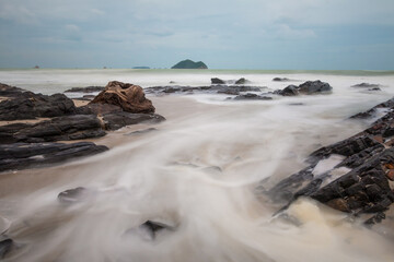 long exposure shot. wave in the sea with stone beach