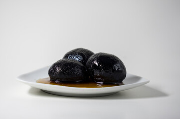 Sweets in molasses on a white saucer