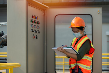 Mechanic inspector engineer check panel broad in factory. women work with panel broad.