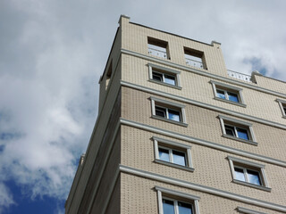 Fototapeta na wymiar upper floors of a high-rise brick residential building
