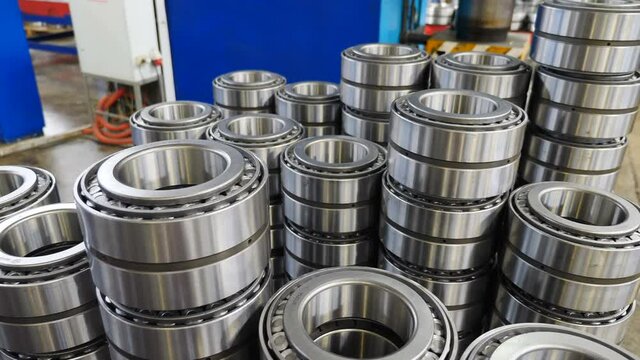 New bearings in factory stacked one on another. Machinery and industry concept. Set of various gears and ball large bearings, spare parts warehouse. Ready items in plant. 4 k video