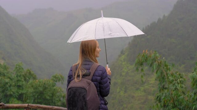 A young woman traveler enjoys her time in a Cat Cat valley. Sa Pa, Northern Vietnam. Travel to Vietnam concept