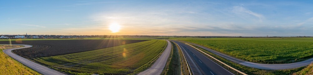 beautiful panorama sunrise over the sown fields and highway of a landside in Heinsberg germany