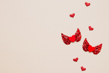 Valentine's day concept two red hearts with wings top view with copy space