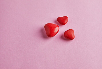 Valentine's day banner with candy hearts on pink background. Top view with a place for your greetings