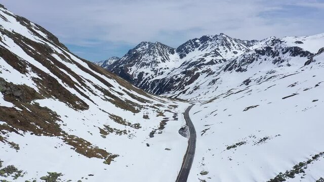 Aerial footage of the Fl&uuml;ela moutain pass in early spring between Davos and Susch in the alps in Canton Graub&uuml;nden in Switzerland