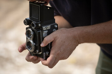 taking a photo with an old twin lens reflex medium format film camera. 