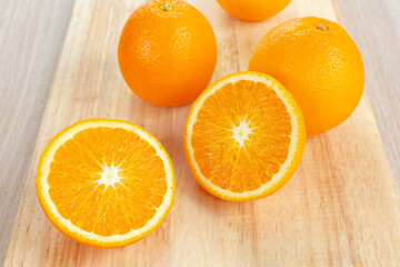 orange with slices on wooden cutting board