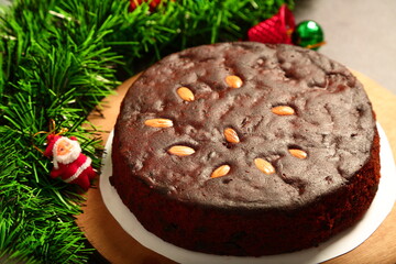 Delicious homemade oven fresh rich plum cake on a holiday background.