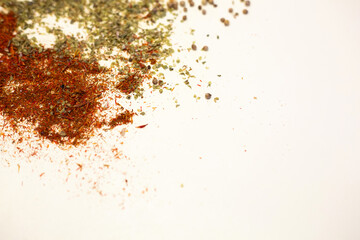 Close-up dried spices, tossed on a white background.