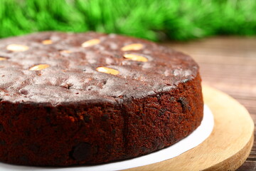 Top view- homemade rich plum cake on a holiday background.