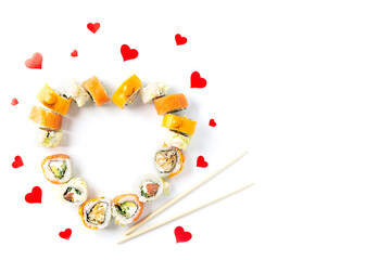 Sushi rolls for Valentine's Day in the form of a heart on a white background. Horizontal orientation, copy space.