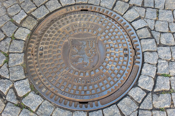 sewer hatch. antique city cast hatch with the inscription "Usti nad Labem" from an ancient city in the Czech Republic