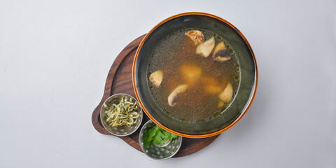 A picture of a bowl of traditional chicken soup served in a bowl over white background.