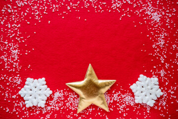 Top view of snowflakes and a Golden star on a red background. Minimal concept of New year and Christmas. Flat lay. snowman