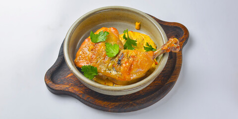 Grilled chicken legs with sauce and gravy in a white bowl over white background. Delicious grilled chicken dinner.