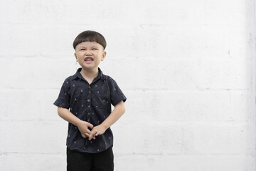 Studio shot portrait of happy little Asian boy on background