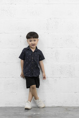 Studio shot portrait of happy little Asian boy on background