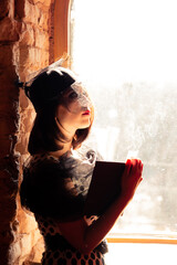 Vintage party. Portrait of a beautiful woman in a hat with a veil.