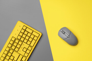 Computer keyboard and mouse in yellow gray colors