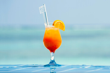 Poolside orange cocktail at a tropical resort