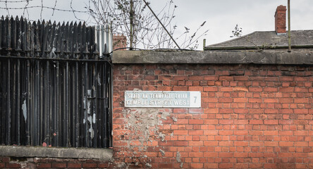 Temple Street West 7 written in English and Irish on a metal plaque