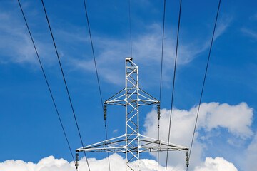 High voltage transmission lines against the blue sky.