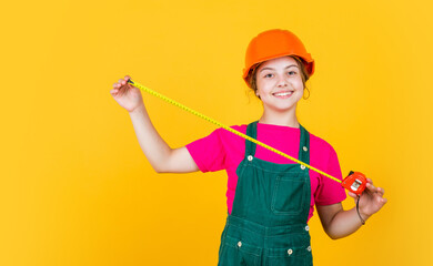Tools to improve yourself. future engineer. happy kid use tape measure repairing tool. building construction site. child architect worker. labor day. childhood development. teenager girl assistant