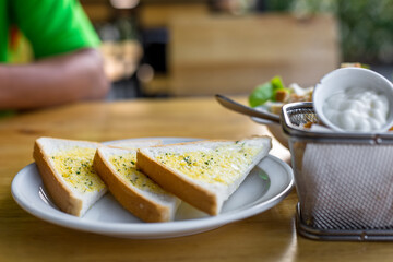 Tasty bread with garlic  on kitchen table.