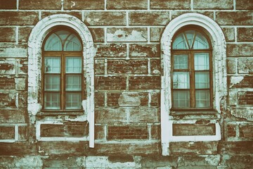 Details of the facade of the old building, an old shabby wall, a decorative wooden window aperity