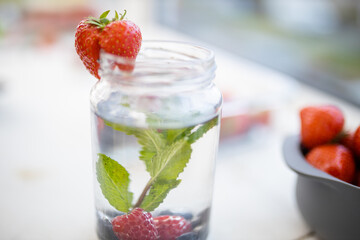 Strawberry on the edge of a mint and berries drink